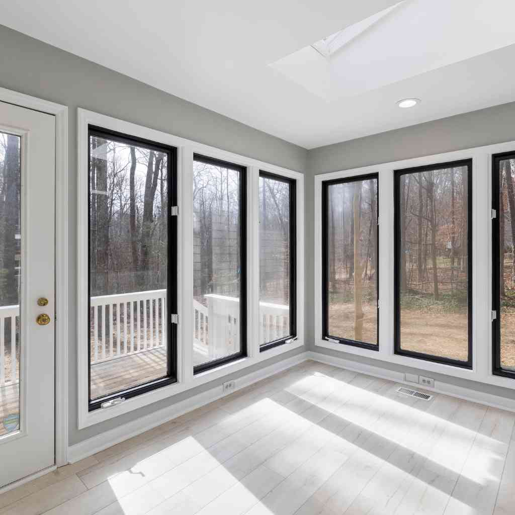 Large windows, glass doors, and open spaces allow natural light to flood the home